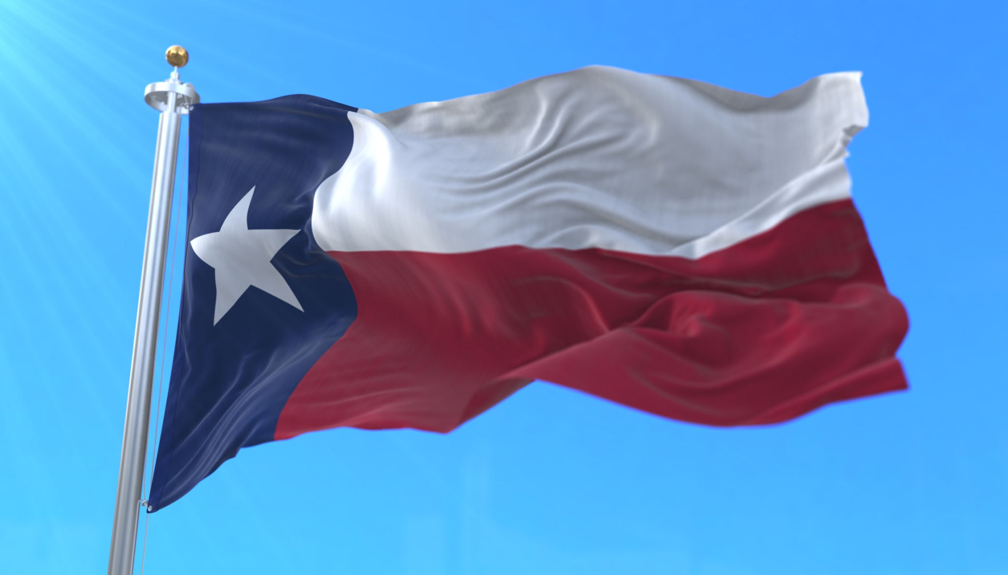 Texas flag flying in the sunlight
