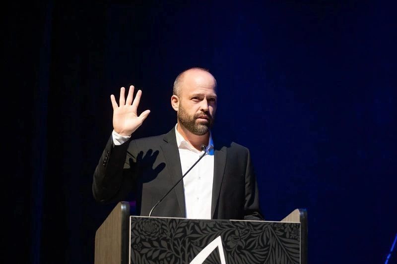 Nathan Hunnicutt speaking on stage